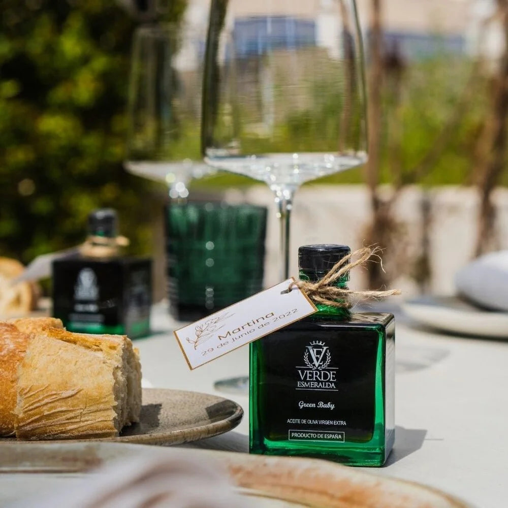 Spanish extra virgin olive oil on table with bread and herbs